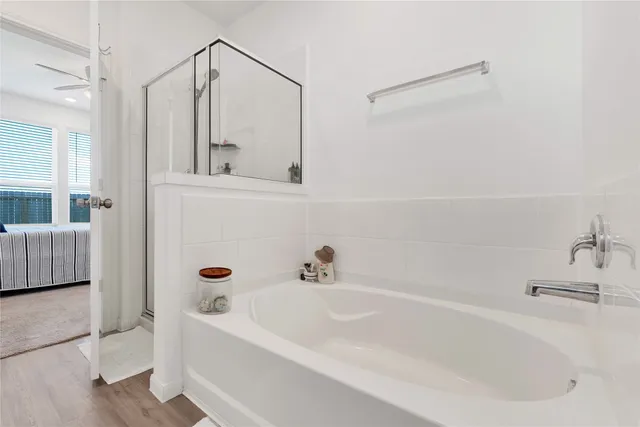 a bathroom with a tub and shower
