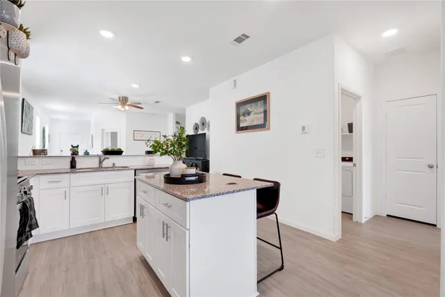 a kitchen with white cabinets and white appliances