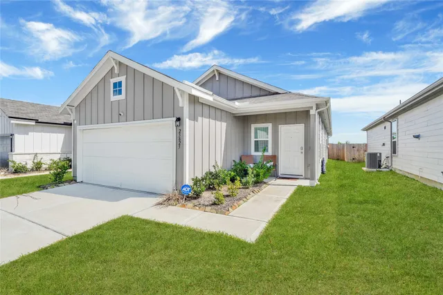 a front view of house with yard and green space