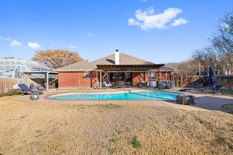 a view of a house with swimming pool and sitting area