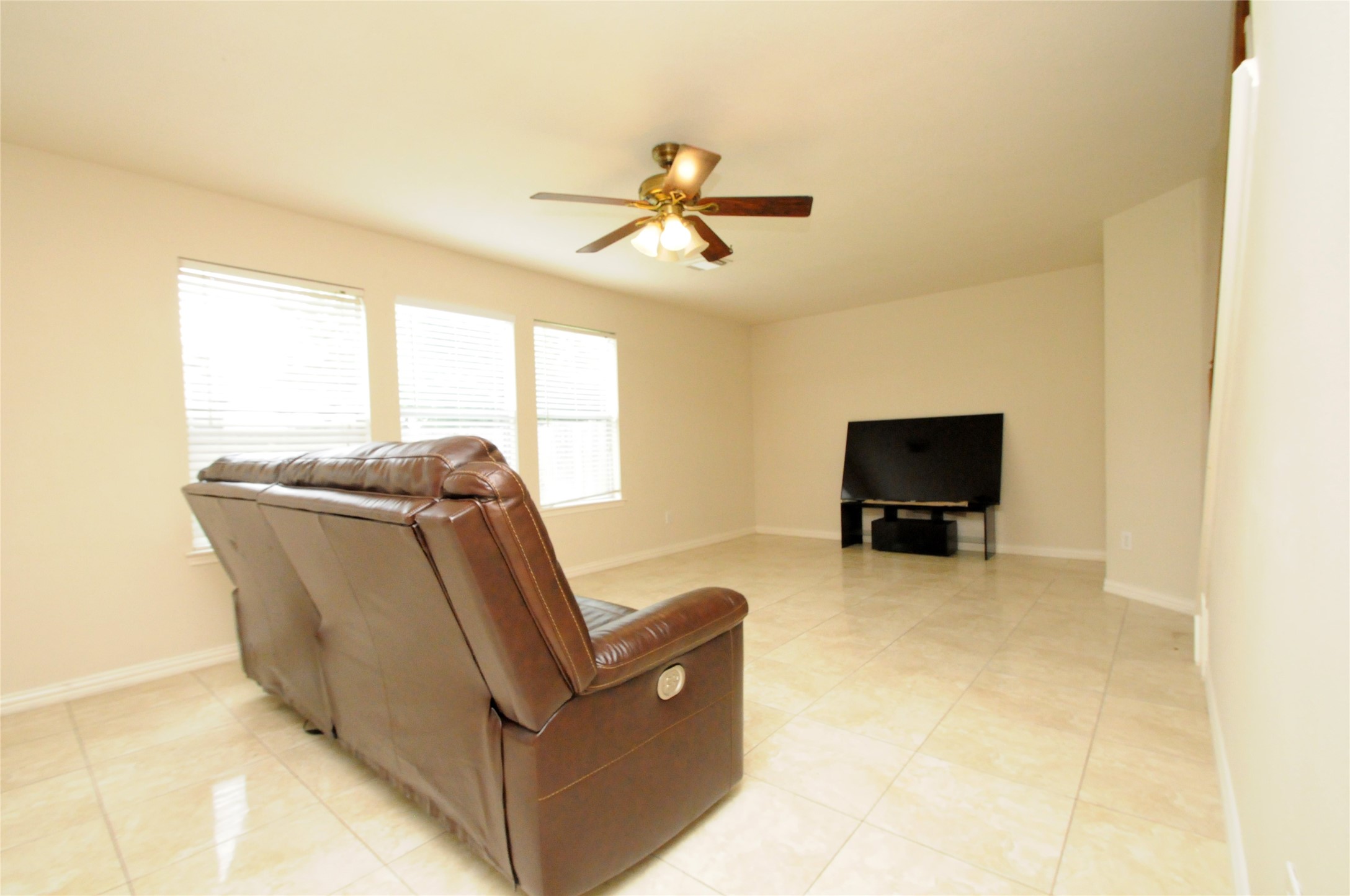 16127 Eaglewood Spring Court Houston, TX 77083 - Photo 11 of 31 a living room with furniture and a flat screen tv