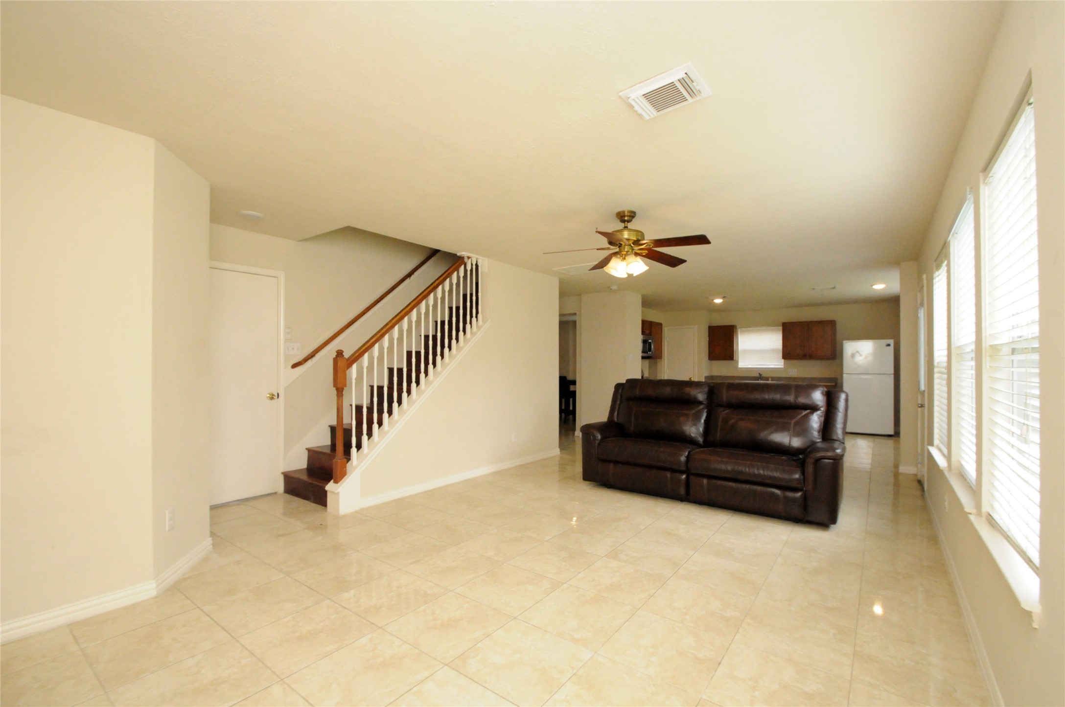 16127 Eaglewood Spring Court Houston, TX 77083 - Photo 12 of 31 a living room with furniture and a chandelier