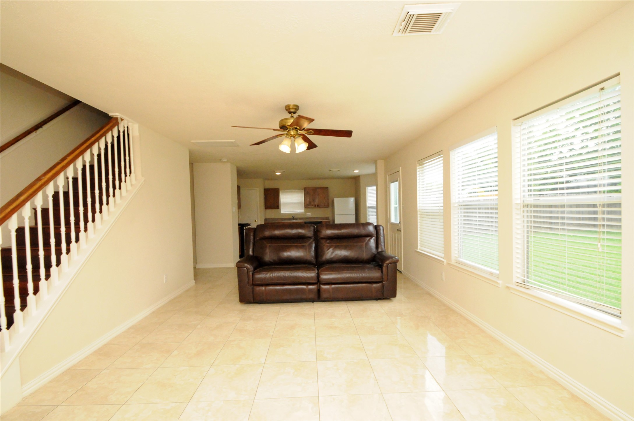 16127 Eaglewood Spring Court Houston, TX 77083 - Photo 13 of 31 a living room with couch cabinet and a large window