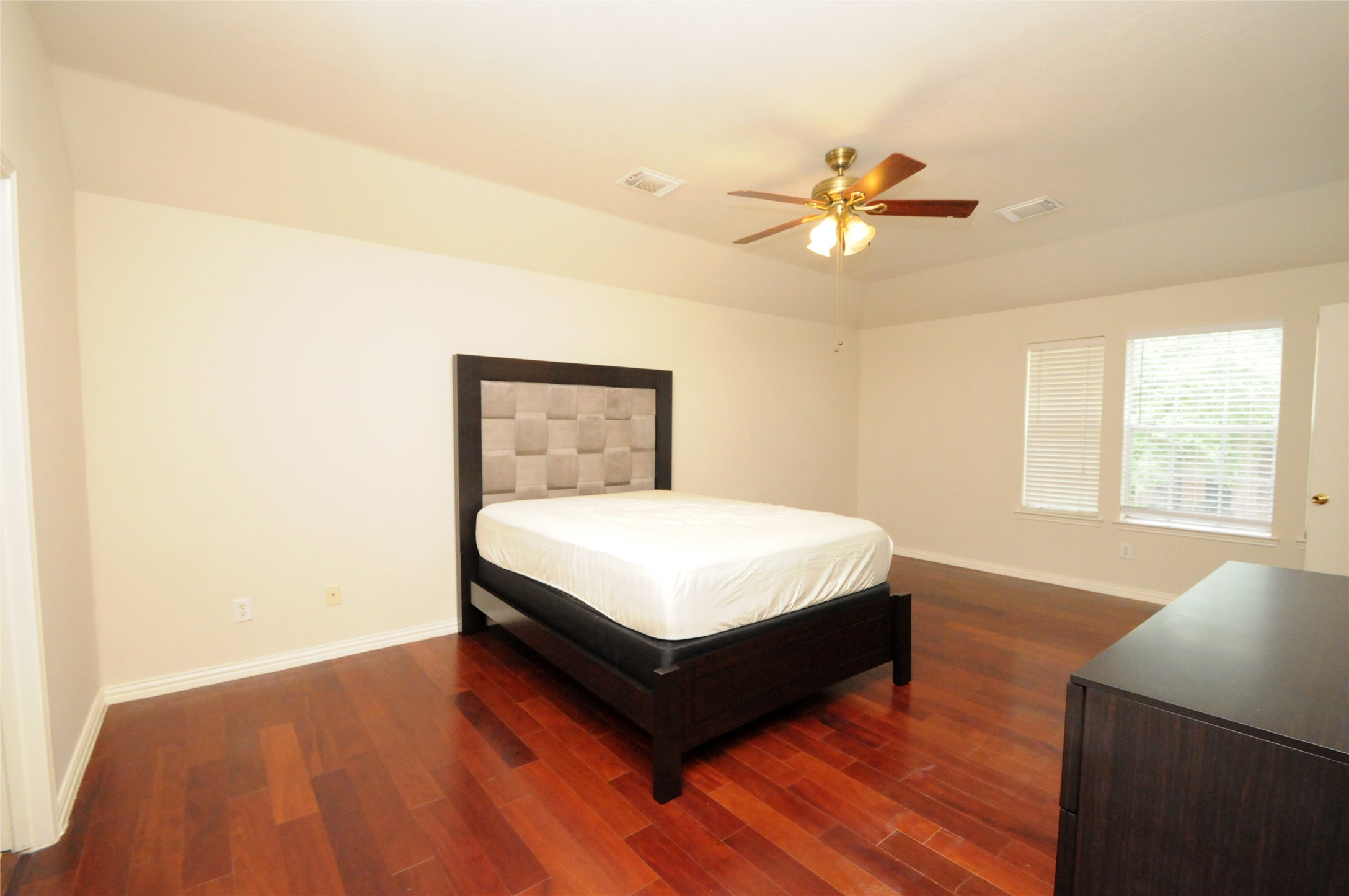 16127 Eaglewood Spring Court Houston, TX 77083 - Photo 14 of 31 a bedroom with a bed and window