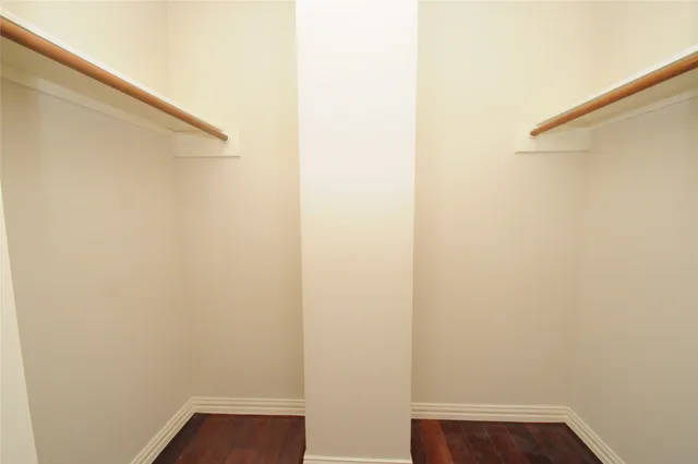 a small space with wooden floor and a window