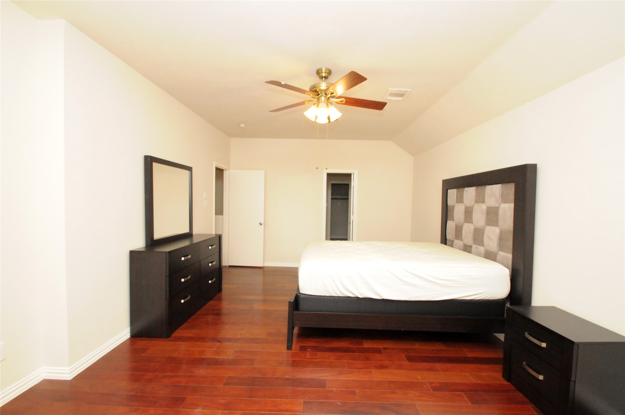 16127 Eaglewood Spring Court Houston, TX 77083 - Photo 17 of 31 a bed room with a bed and a dresser