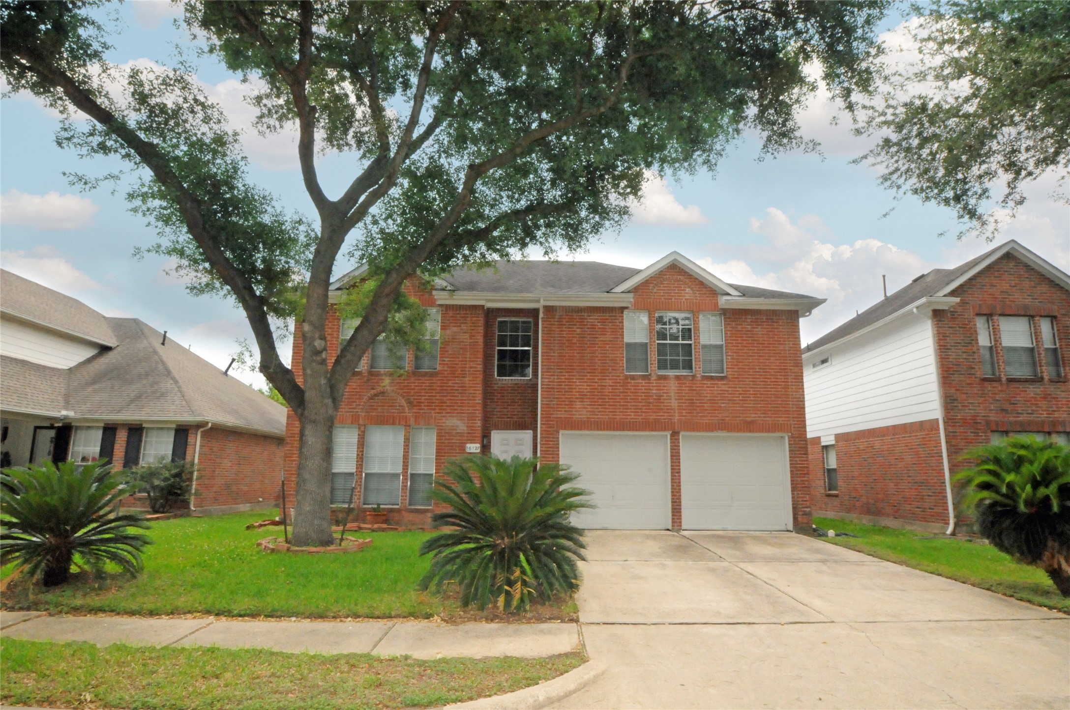 16127 Eaglewood Spring Court Houston, TX 77083 - Photo 2 of 31 a front view of a house with a garden