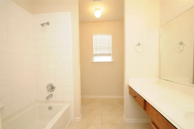 a bathroom with a bathtub and shower
