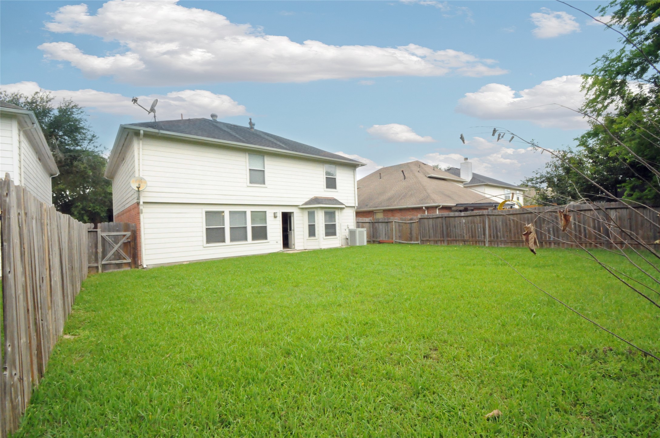16127 Eaglewood Spring Court Houston, TX 77083 - Photo 30 of 31 a view of a house with a backyard and a garden