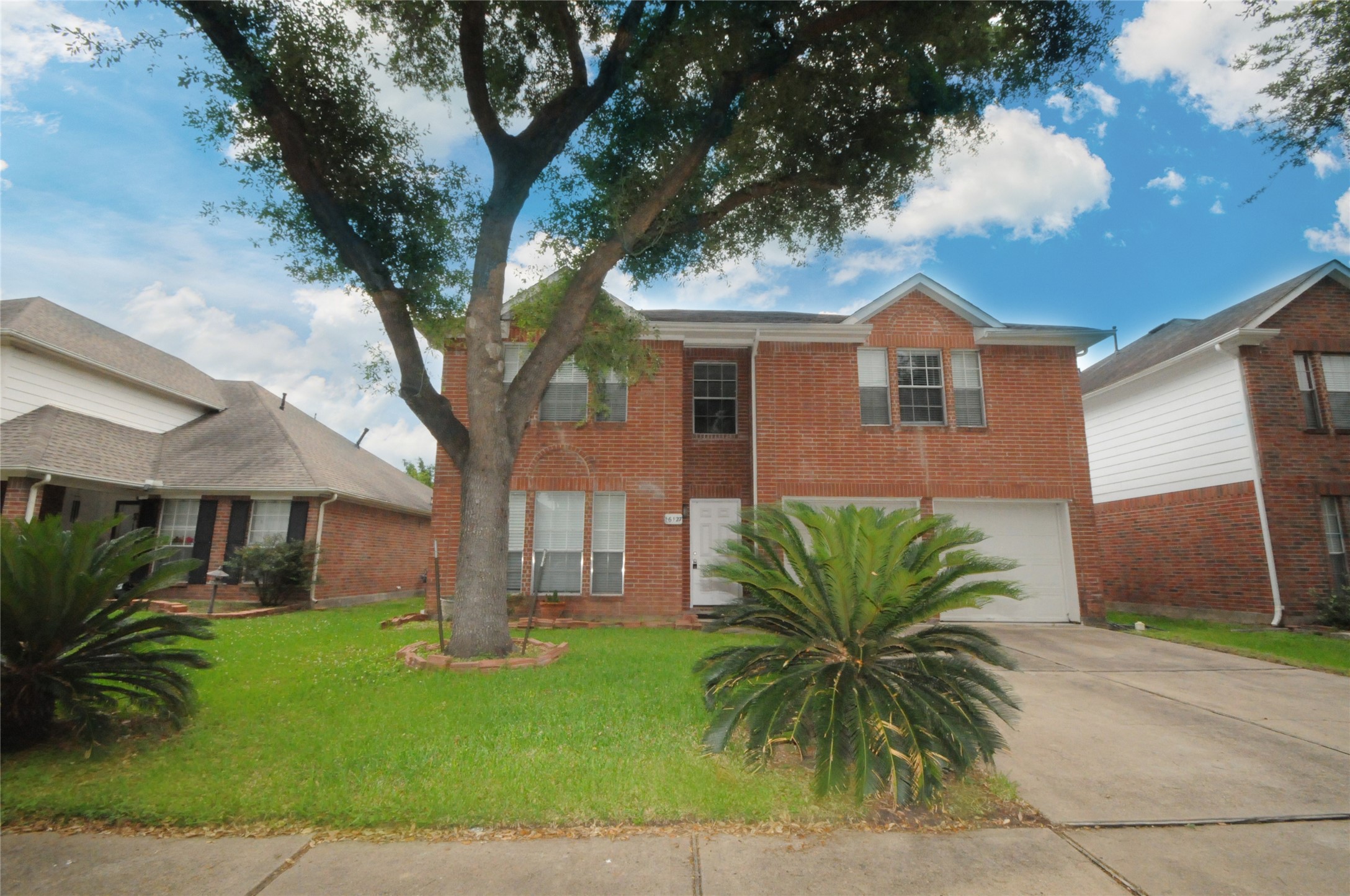 16127 Eaglewood Spring Court Houston, TX 77083 - Photo 3 of 31 a front view of a house with a garden