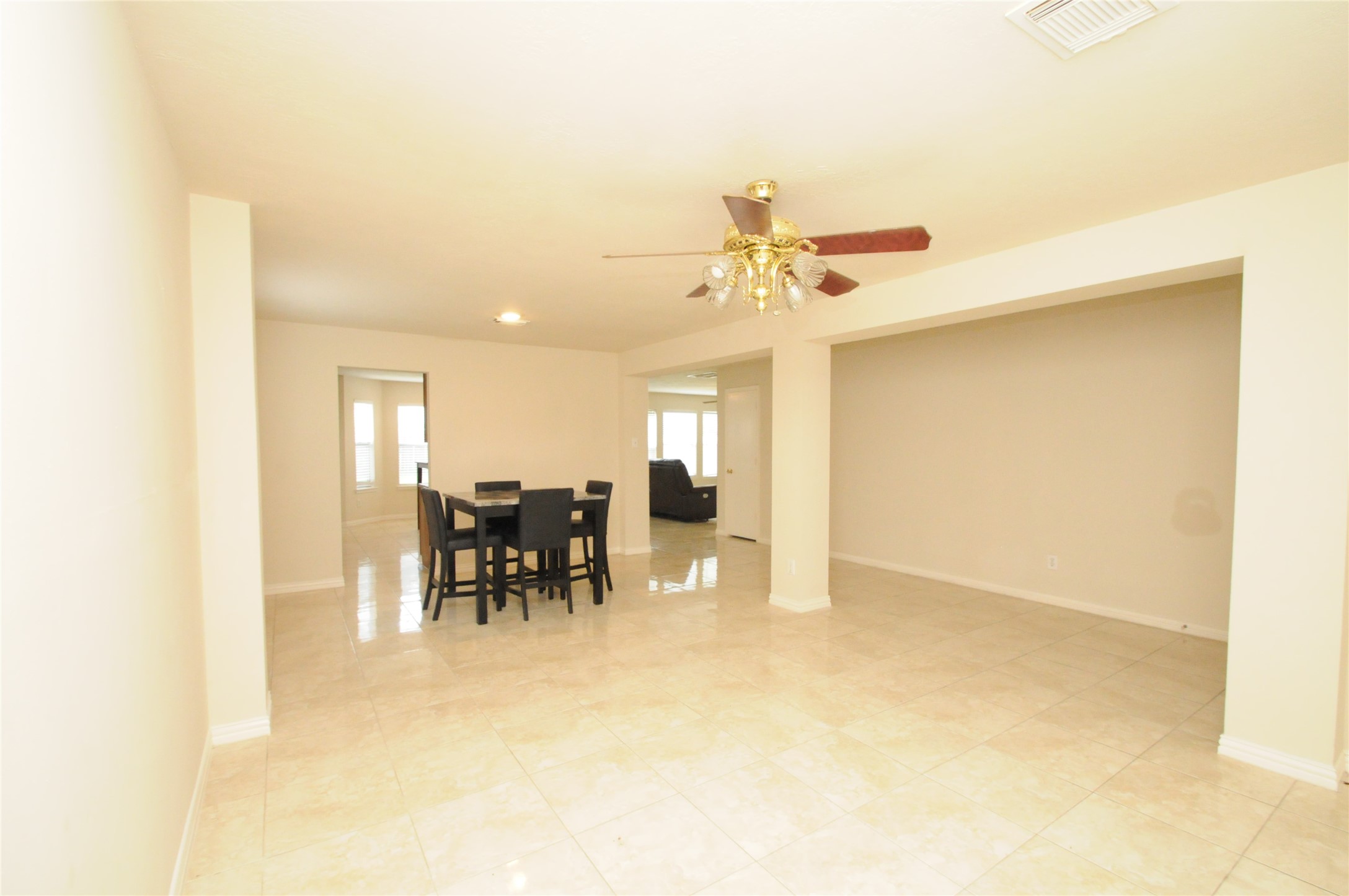 16127 Eaglewood Spring Court Houston, TX 77083 - Photo 5 of 31 a view of a dining room with furniture and a chandelier fan