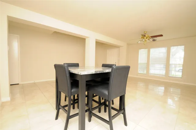 a dining room with furniture and window