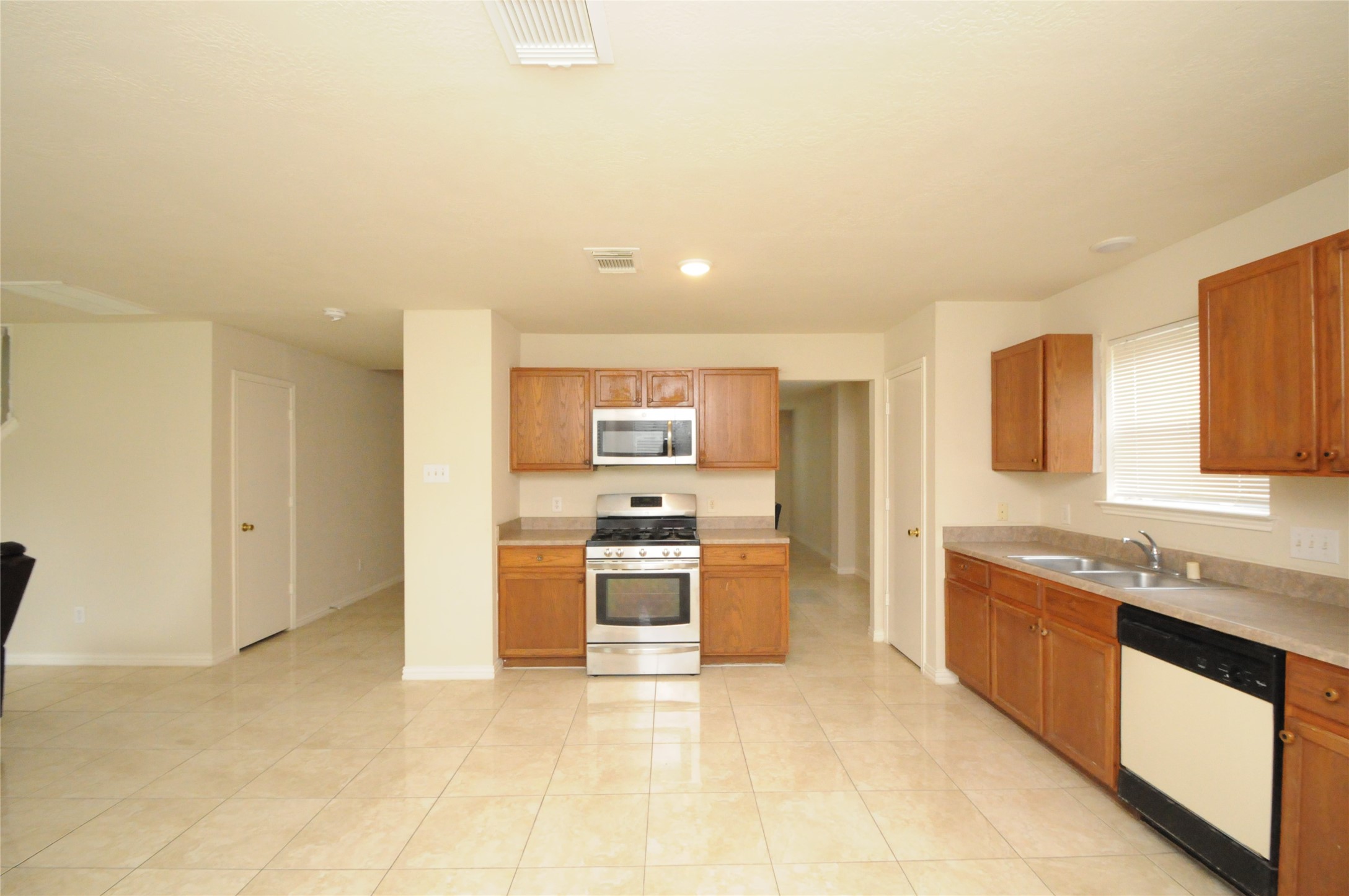 16127 Eaglewood Spring Court Houston, TX 77083 - Photo 10 of 31 a large kitchen with stainless steel appliances granite countertop a large stove top oven a sink and dishwasher