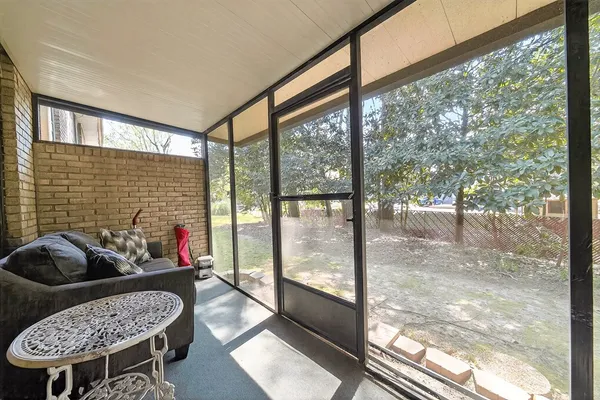 a backyard of a house with barbeque oven and outdoor seating