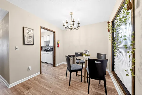 a kitchen with granite countertop wooden cabinets stove top oven and sink