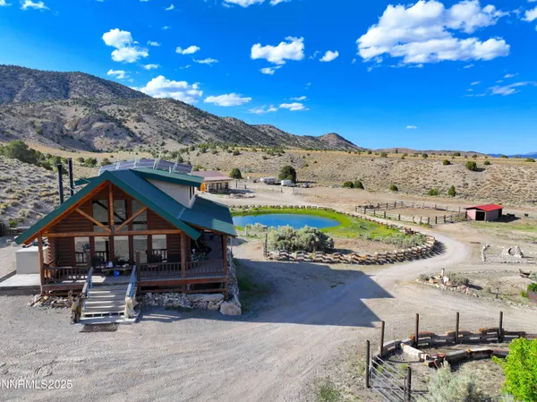 a view of a house with swimming pool and sitting area