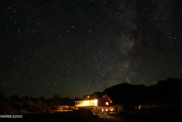 a backyard of a house with yard table and chairs