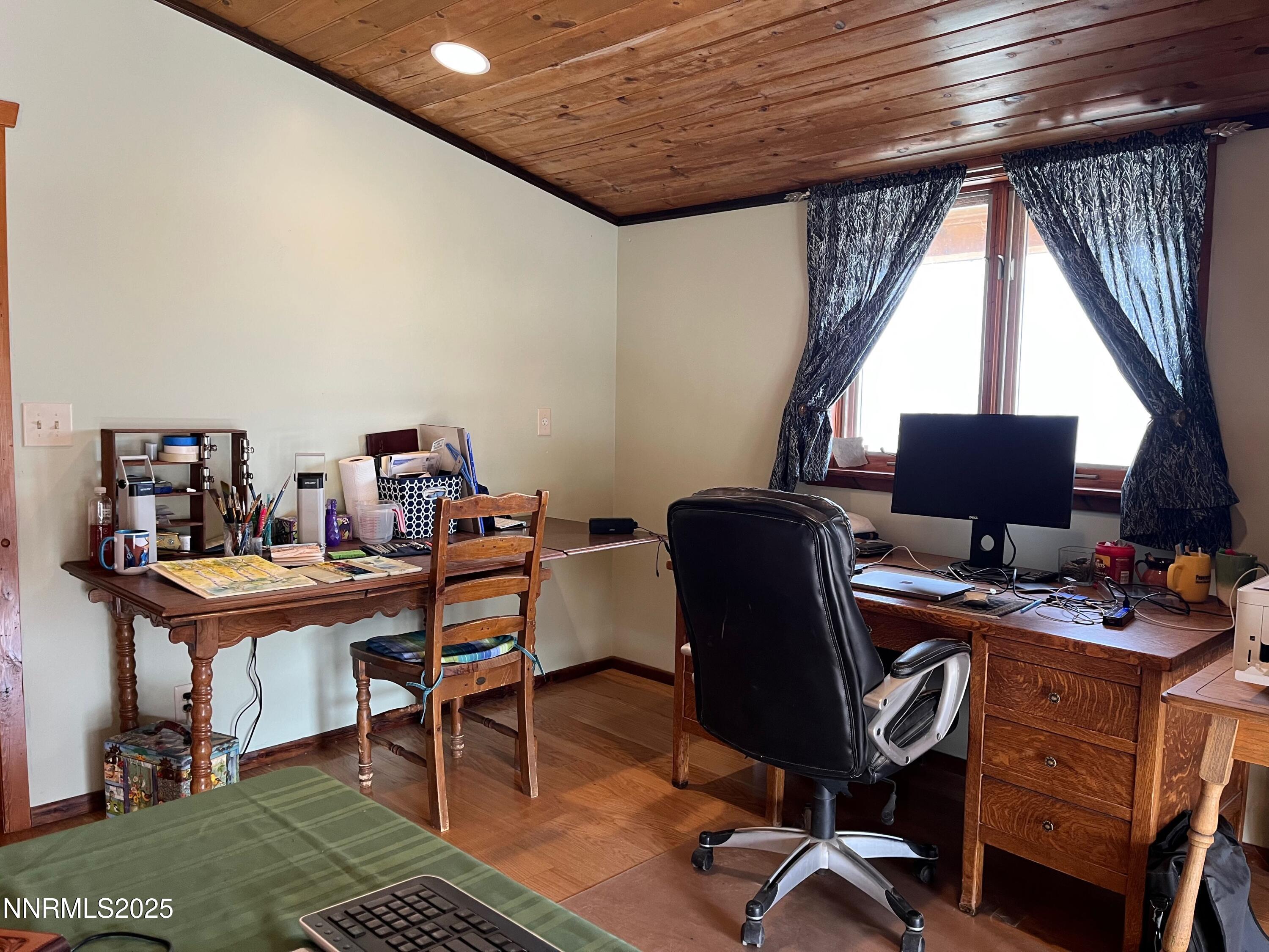 3350 Ikes Cyn Road Round Mountain, NV 89045 - Photo 21 of 38 a view of a workspace with furniture and a window