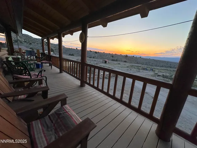 a view of a balcony with chairs and wooden floor