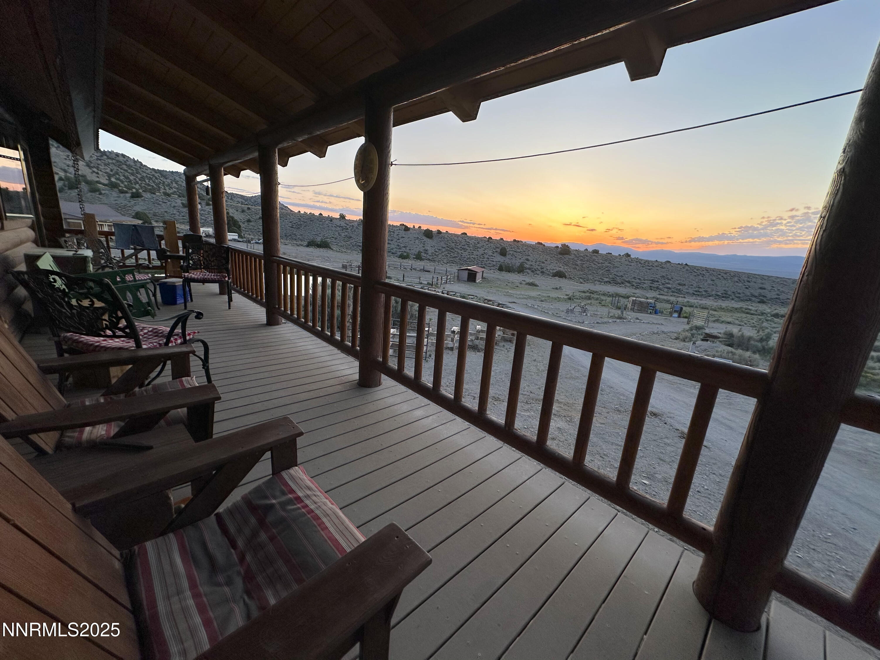 3350 Ikes Cyn Road Round Mountain, NV 89045 - Photo 3 of 38 a view of a balcony with chairs and wooden floor