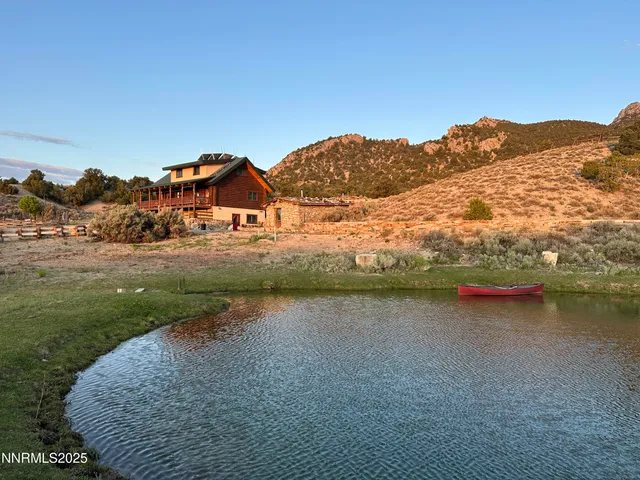 a view of a dry field with mountains in the background