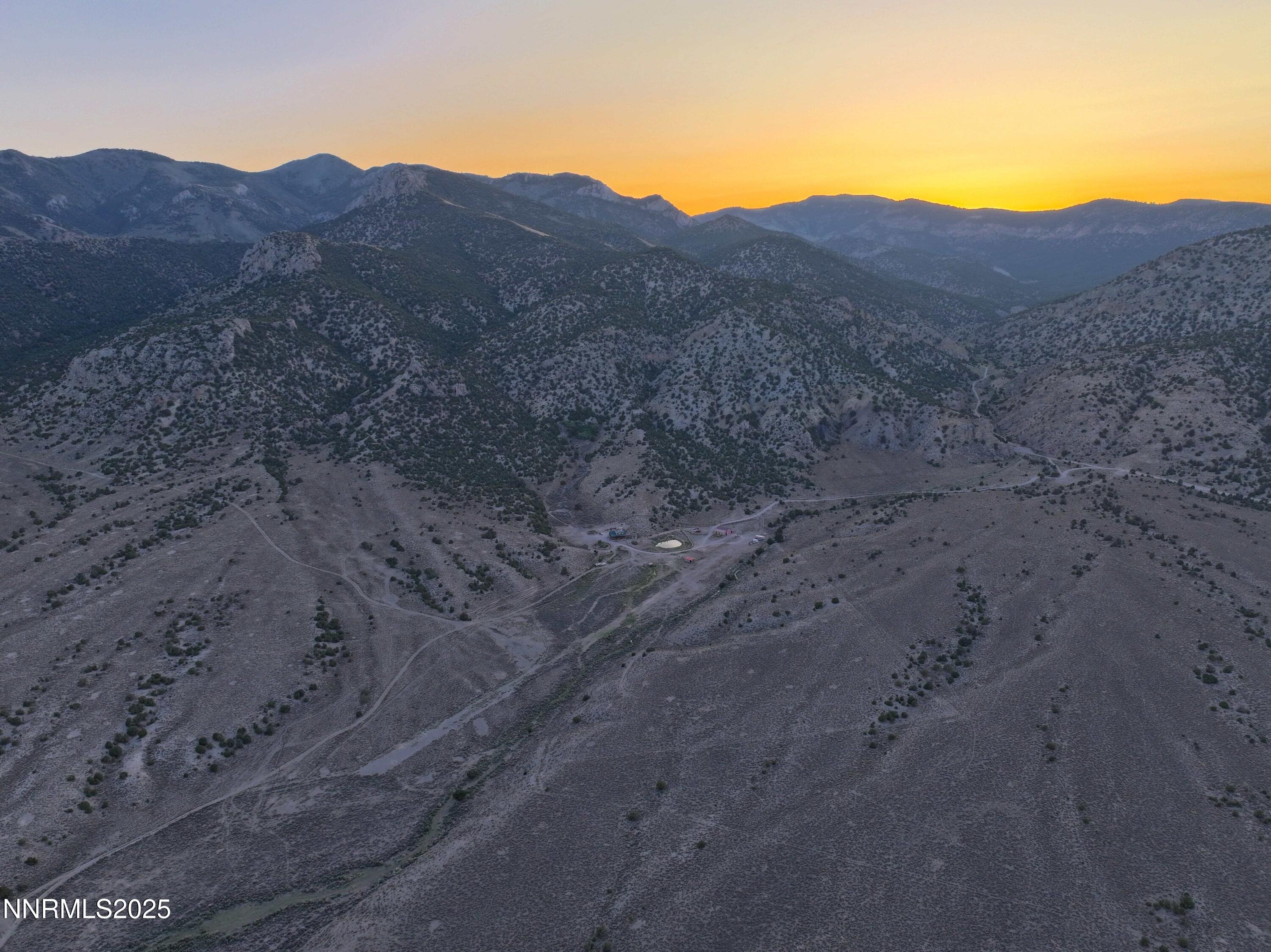 3350 Ikes Cyn Road Round Mountain, NV 89045 - Photo 38 of 38 a view of a dry field with mountains in the background