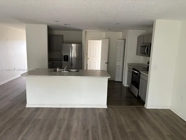 a view of a kitchen cabinets and wooden floor