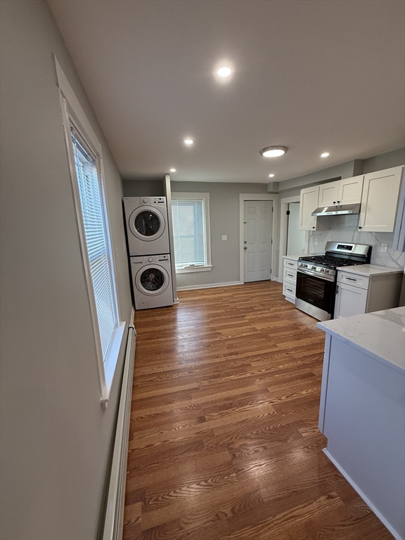 a large kitchen with stainless steel appliances granite countertop a granite counter tops and a wooden floors