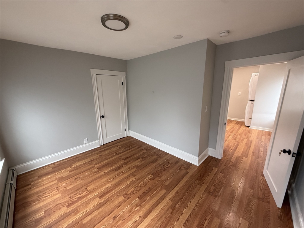 1922 Columbus Avenue, Unit 3 Boston, MA 02119 - Photo 12 of 22 a view of empty room with wooden floor