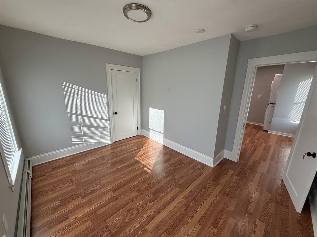 1922 Columbus Avenue, Unit 3 Boston, MA 02119 - Photo 14 of 22 a view of empty room with wooden floor