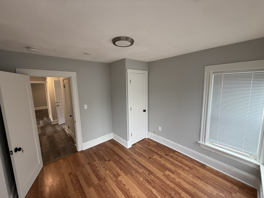 1922 Columbus Avenue, Unit 3 Boston, MA 02119 - Photo 15 of 22 a view of a room with wooden floor and bathroom