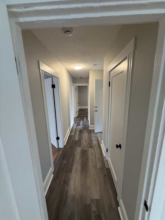 1922 Columbus Avenue, Unit 3 Boston, MA 02119 - Photo 18 of 22 a view of a hallway with wooden floor and staircase