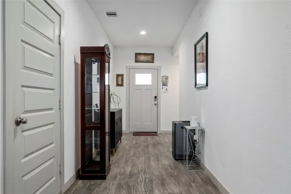 a view of hallway with wooden floor