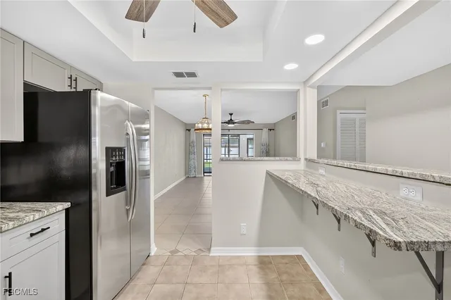 a kitchen with stainless steel appliances granite countertop a refrigerator and a sink