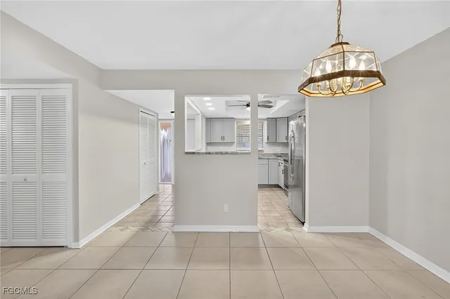 a view of kitchen with cabinets and window