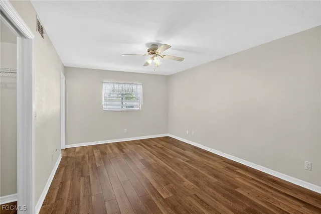 wooden floor in an empty room with a window