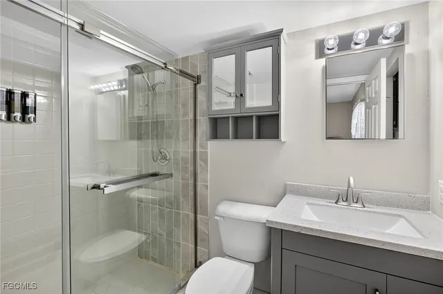 a bathroom with a toilet sink shower and mirror