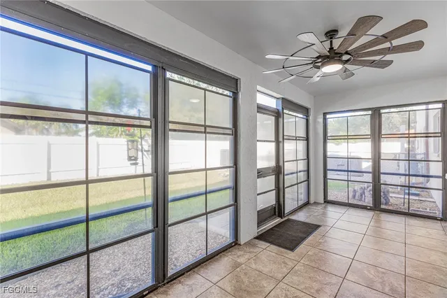 a view of a livingroom with a ceiling fan and window