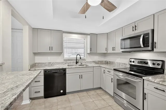 a kitchen with stainless steel appliances granite countertop a stove sink microwave and cabinets