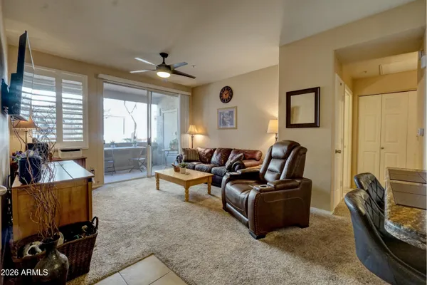 a living room with furniture a large window and a flat screen tv