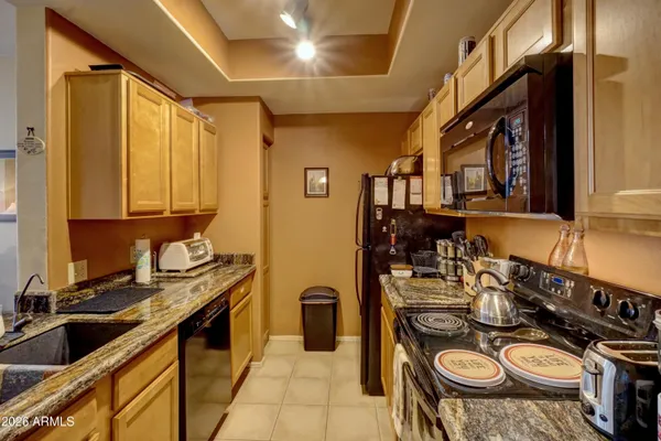 a kitchen with sink stove and cabinets