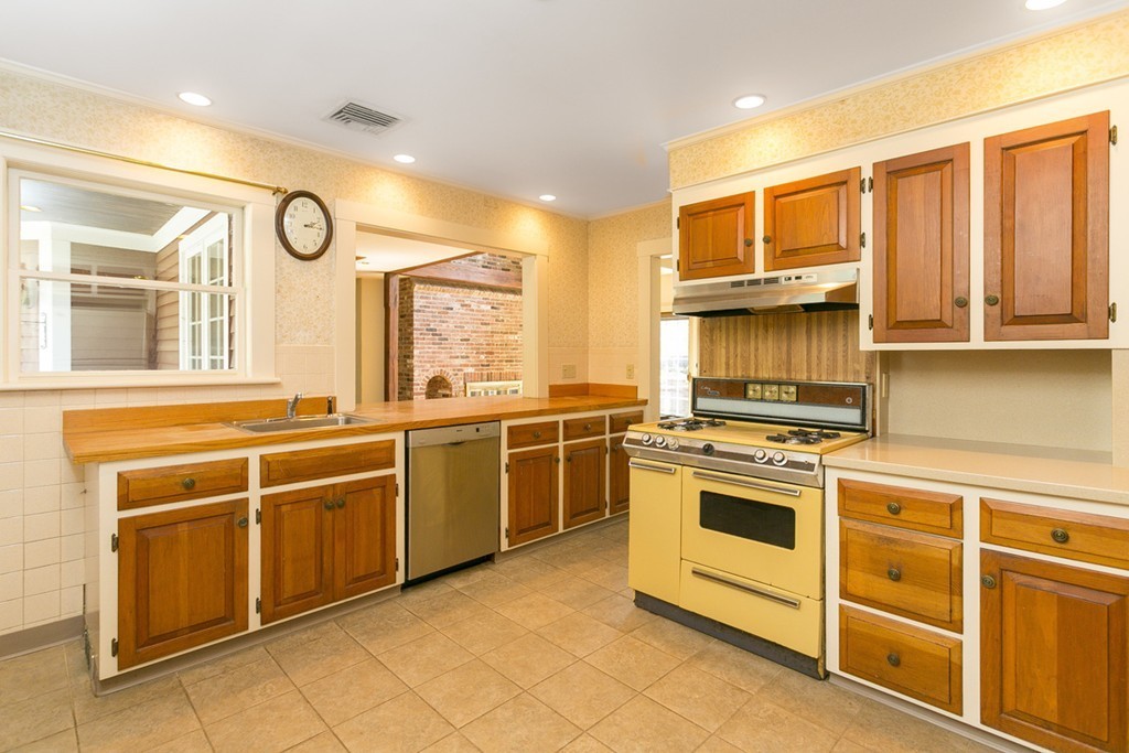 25 Rutledge Road Natick, MA 01760 - Photo 12 of 30 a kitchen with stainless steel appliances granite countertop a stove and a sink