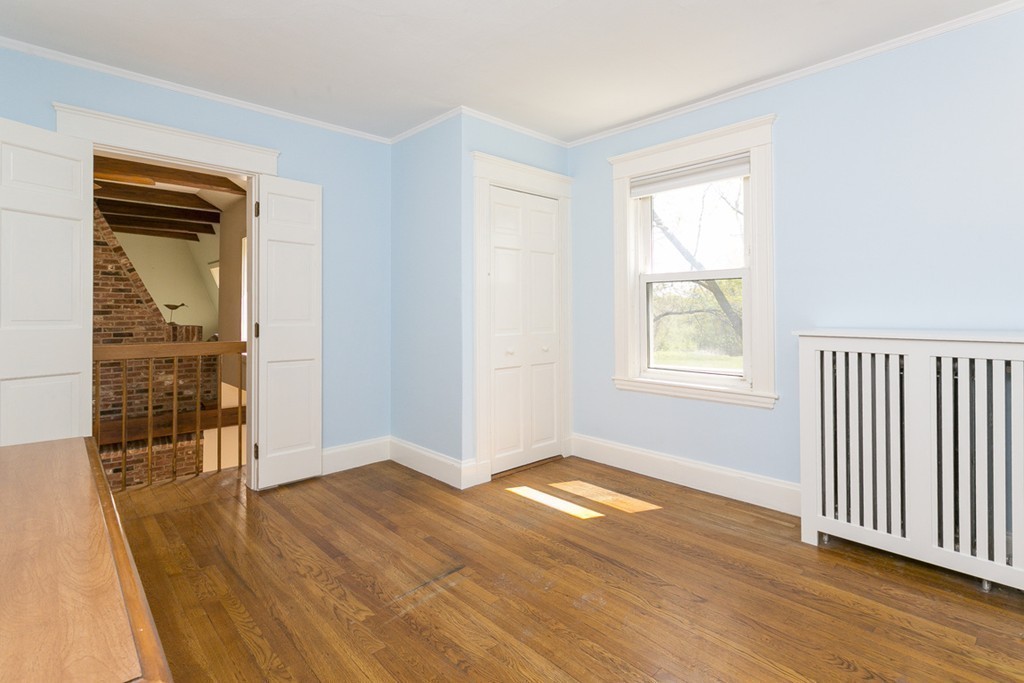 25 Rutledge Road Natick, MA 01760 - Photo 23 of 30 an empty room with wooden floor and a window