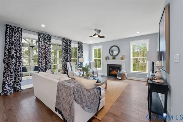 a living room with furniture a fireplace and a large window