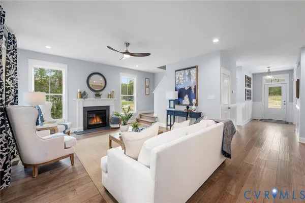 a living room with furniture a clock and a fireplace