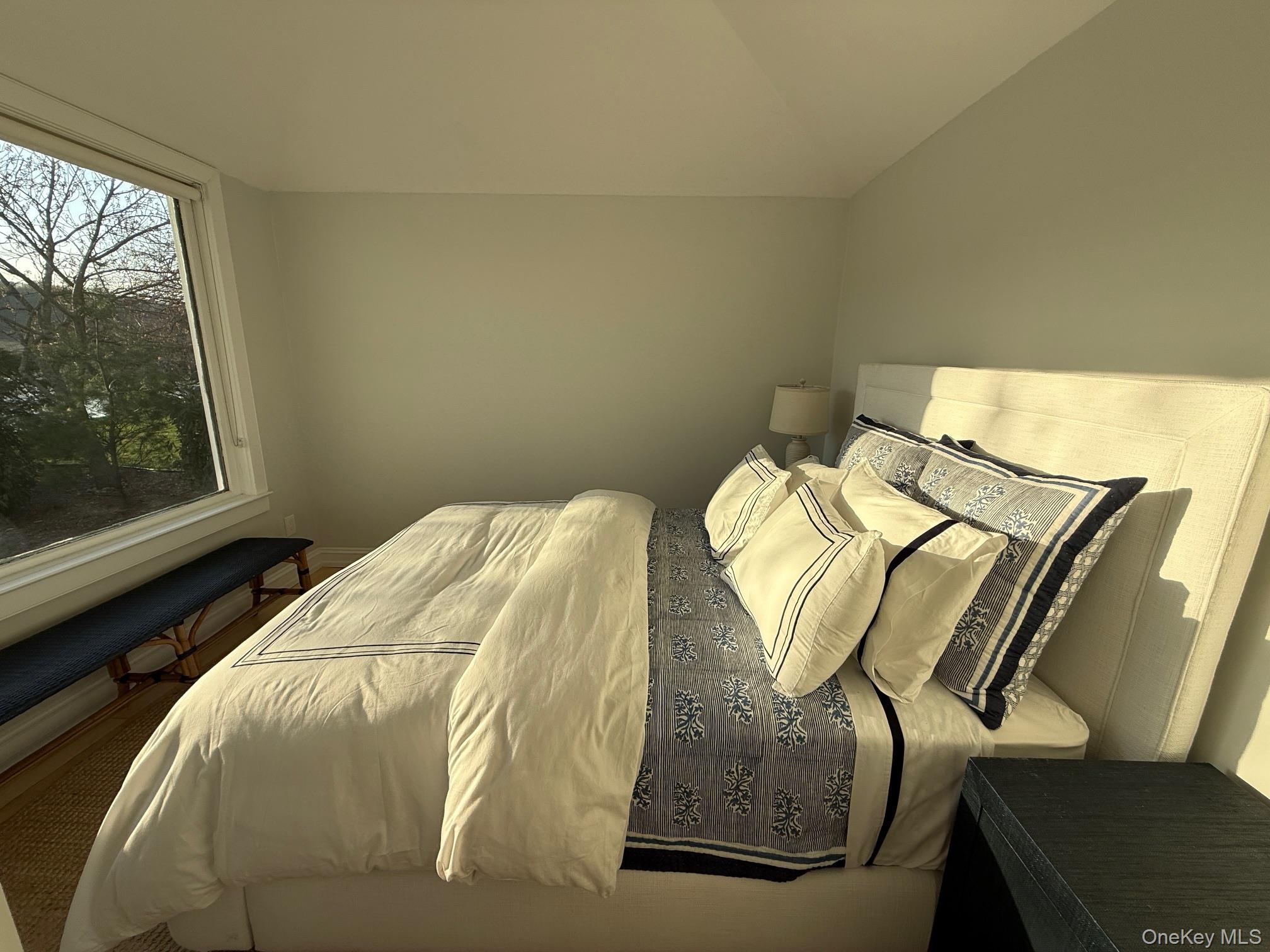329 Centre Island Road Centre Island, NY 11771 - Photo 13 of 28 a bed sitting in a bedroom next to a window