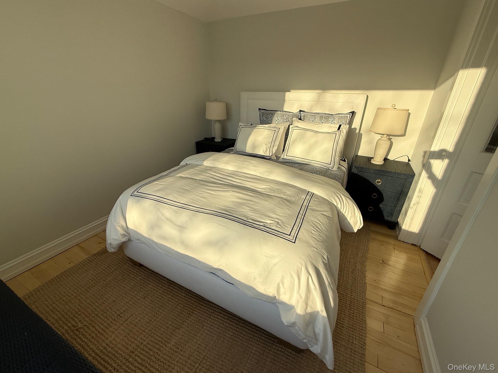 329 Centre Island Road Centre Island, NY 11771 - Photo 14 of 28 a bed sitting in a bedroom next to a window