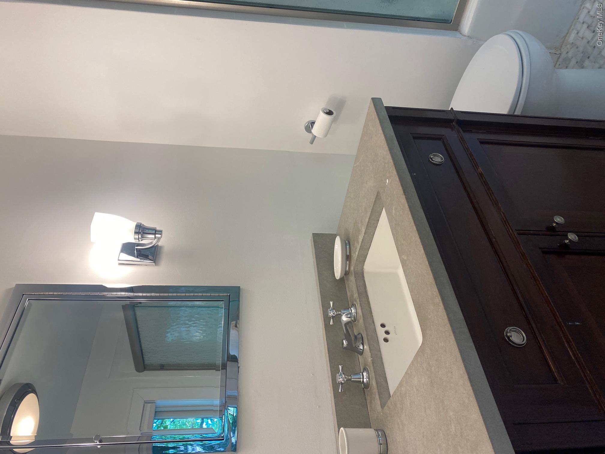 329 Centre Island Road Centre Island, NY 11771 - Photo 15 of 28 a bathroom with a granite countertop sink a toilet and mirror