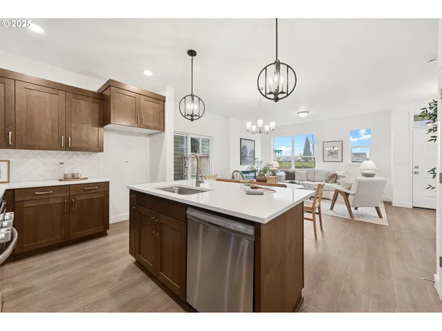 a kitchen with a sink appliances and cabinets