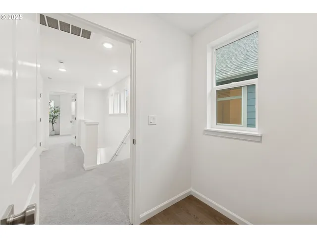 a view of an entryway with wooden floor
